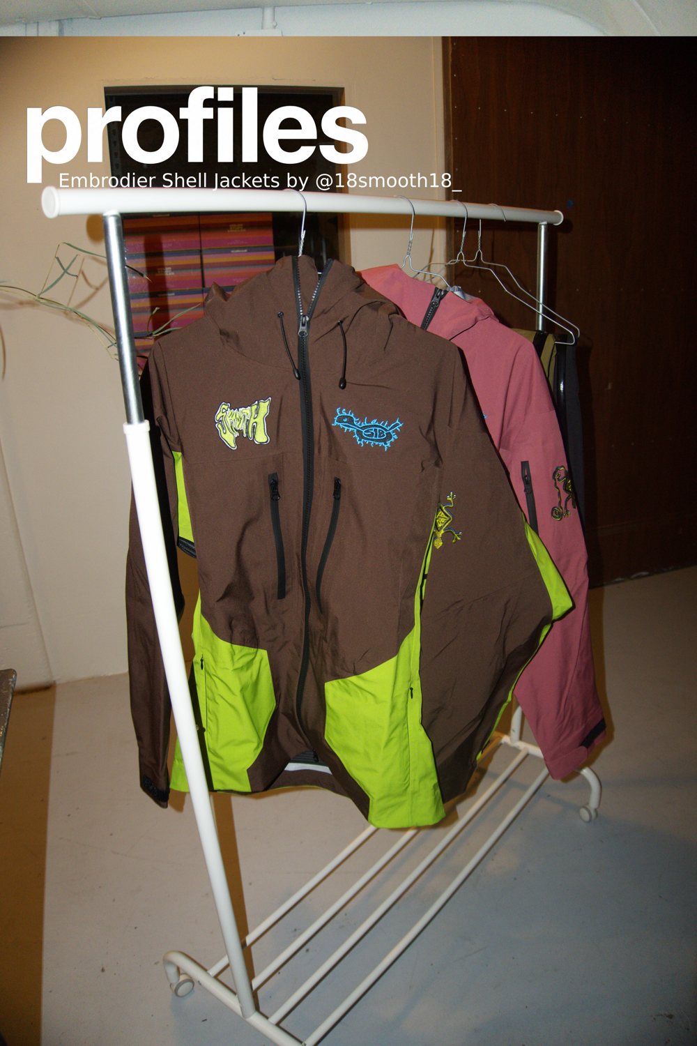 Embroidered shell jackets by 18smooth18 on a rack